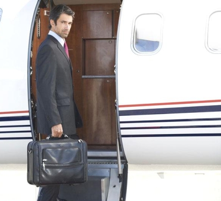 Rich, wealthy man boarding , leaving on to a plane