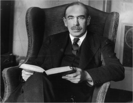 John Maynard Keynes sitting in chair with book